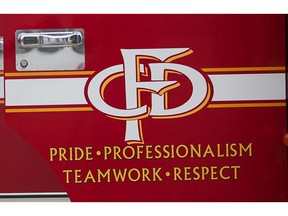 File - The Calgary Fire Department logo is seen on a fire truck door.