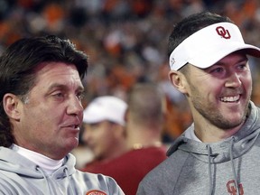Oklahoma State coach Mike Gundy, left, talks with Oklahoma coach Lincoln Riley in this photo from Nov. 30, 2019.