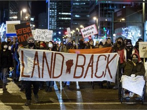 Demonstrators march down Jasper Avenue towards the Alberta Legislature, as they rally against the use of legal injunctions, police forces, and criminalizing state tactics against the Wet'suwet'en Nation in their fight against the Coastal Gaslink Pipeline, Monday, Nov. 22, 2021.