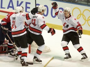 Jarome Iginla (centre) celebrates Team Canada’s goal with Simon Gagne and Joe Sakic in the men’s hockey gold medal game at the Salt Lake City Olympics. Canada defeated the United States 5-2.