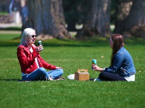 Gillian Meades, left, and Charlotte Van Horne enjoy the day in Riley Park on Monday, May 10, 2021.