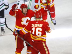 The Calgary Flames’ Milan Lucic celebrates with Nikita Zadorov after scoring against the Dallas Stars at the Scotiabank Saddledome in Calgary on Thursday, Nov. 4, 2021.