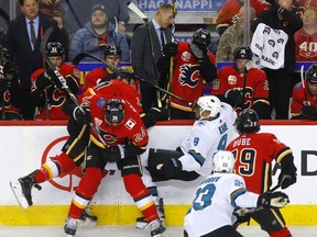 The Calgary Flames' Milan Lucic battles the San Jose Sharks' Evander Kane at the Scotiabank Saddledome in Calgary on Feb. 4, 2020.