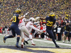 Michigan Wolverines running back Hassan Haskins (No. 25) rushes for a touchdown in the second half against the Ohio State Buckeyes at Michigan Stadium in Ann Arbor, Mich., on Saturday, Nov. 27, 2021.