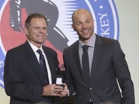 This year's six Hockey Hall of Fame inductees received their rings at a ceremony at the Hockey Hall Grand Hall and in Toronto (Pictured) NHL Hall of fame Mike Gartner (L) presents Jarome Iginla with his ring. Iginla will best be known for being a Calgary Flames for 15 years and winning two Olympic gold medals on Friday November 12, 2021. Jack Boland/Toronto Sun/Postmedia Network