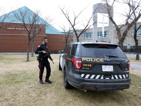 Calgary police attend Bishop McNally High School in northeast Calgary following a stabbing on Wednesday, Nov. 3, 2021. A teenage boy was taken to hospital in stable condition.