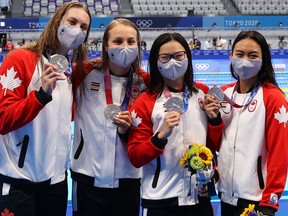 Canada’s 4x100-metre women’s relay team of Kayla Sanchez, Margaret MacNeil, Rebecca Smith and Penny Oleksiak celebrate their silver-medal performance at the Tokyo Olympics on July 25, 2021.