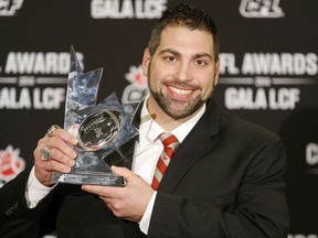 Calgary Stampeders long-snapper Randy Chevrier, holds the  Tom Pate Memorial Award in November 2014. The award honours sportsmanship and a significant contribution to a player’s team, community and CFL Players’ Association.