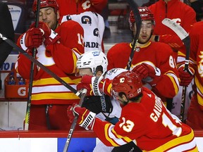 Flames forward Johnny Gaudreau battles the San Jose Sharks' Lane Pederson in the second period of Tuesday night's game at Scotiabank Saddledome in Calgary.