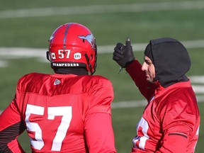 Randy Chevrier, left, who recently came out of retirement, chats with place-kicker Rene Paredes during practice at McMahon Stadium on Wednesday.