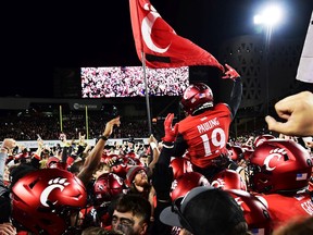 Will Pauling of the Cincinnati Bearcats celebrates with fans after their 35-20 win over the Houston Cougars in the American Athletic Conference championship game at Nippert Stadium in Cincinnati, Ohio, on Saturday, Dec. 4, 2021.