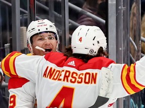 Flames forward Matthew Tkachuk celebrates his goal with Rasmus Andersson during the third period against the Kraken at Climate Pledge Arena on Thursday in Seattle.