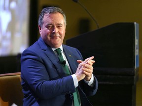 Alberta Premier Jason Kenney sanitizes his hands as he prepares to take questions after a noon hour speech at a Calgary Chamber of Commerce event in Calgary at the Westin Hotel on Wednesday, December 8, 2021.