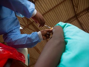 A teenager gets his first jab of the COVIE-19 vaccine in Chinhoyi, Zimbabwe, Wednesday, Dec. 15, 2021.