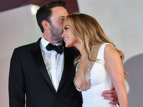 Ben Affleck kisses actress and singer Jennifer Lopez as they arrive for the screening of the film "The Last Duel" on Sept. 10, 2021 during the 78th Venice Film Festival.