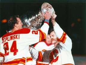 Calgary Flames Jim Peplinski and Lanny McDonald participate in the 1989 Stanley Cup celebration at the Saddledome. Postmedia file photo.