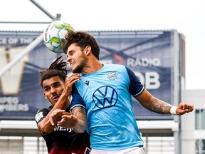 HFX Wanderers star João Morelli -- pictured here battling for a ball with Cavalry FC's Mohamed Farsi -- was named CPL Player of the Year on Tuesday.