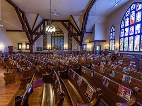 Photos of congregants have been taped to the pews at Hillhurst United Church to make the church feel less empty while Minister John Pentland gives an online sermon. Places of worship will be allowed to reopen next week in Calgary.