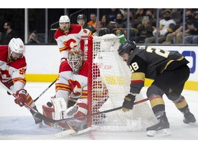 The Vegas Golden Knights’ William Carrier takes a shot on Calgary Flames goaltender Jacob Markstrom while Oliver Kylington defends at T-Mobile Arena in Las Vegas on Sunday, Dec. 5, 2021.