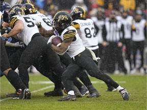 Dec 5, 2021; Toronto, Ontario, CAN; Hamilton Tiger-Cats running back Don Jackson (5) rushes the ball against the Toronto Argonauts during the Canadian Football League Eastern Conference Final game at BMO Field. Hamilton defeated Toronto. Mandatory Credit: John E. Sokolowski-USA TODAY Sports