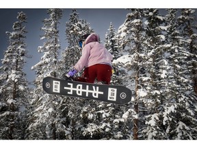 A snowboarder takes to the air at Lake Louise, as of last Sunday, the ski resort had three terrain parks open with a combined total of 32 different jumps. AL CHAREST / POSTMEDIA