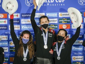 Canada's Ivanie Blondin celebrates with teammates, left to right, Isabelle Weidemann, and Valerie Maltais following their victory in the women's team pursuit at the ISU World Cup speed skating event in Calgary on Saturday.