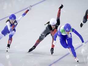 Canada’s Ivanie Blondin, centre left, and Italy’s Francesca Lollobrigida, centre right, race to second and first position, respectively, during the women’s mass start competition at the ISU World Cup speedskating event in Calgary on Sunday, Dec. 12, 2021.