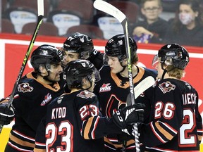 The Calgary Hitmen celebrate a goal from Tyson Galloway during first-period action against the Moose Jaw Warriors at the Saddledome on Thursday night.