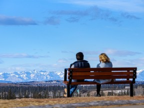 People spend the sunny afternoon at North Glenmore Park with a clear view of the Rocky Mountains on Sunday, January 23, 2022.