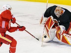 Calgary Flames forward Matthew Tkachuk takes a shot on goal while Jacob Markstrom defends during practice at Scotiabank Saddledome on Tuesday, Dec. 28, 2021.