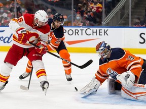 Edmonton Oilers goaltender Mikko Koskinen makes a save against the Calgary Flames’ Brad Richardson at Rogers Place in Edmonton on Saturday, Jan. 22, 2022.