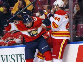 Erik Gudbranson of the Calgary Flames takes on Ryan Lomberg of the Florida Panthers at FLA Live Arena in Sunrise, Florida on January 4, 2022.
