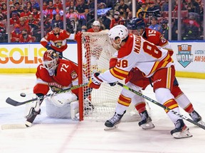 The Calgary Flames’ Andrew Mangiapane Flames centres the puck against Florida Panthers goaltender Sergei Bobrovsky at FLA Live Arena in Sunrise, Fla., on Jan. 4, 2022.