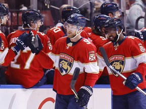 Sam Bennett (centre) and Anthony Duclair (right) of the Florida Panthers celebrate Bennett’s goal against the Dallas Stars with teammates at FLA Live Arena in Sunrise, Fla., on Friday, Jan. 14, 2022.