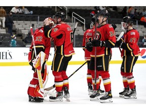 Stockton Heat defenceman Ilya Solovyov plants a smooch on the mask of goaltender Dustin Wolf after a recent victory. The Calgary Flames' farm team currently sits atop the standings in the American Hockey League's Pacific Division.