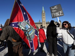 A supporter carries a U.S. Confederate flag during the Freedom Convoy protesting COVID-19 vaccine mandates and restrictions in front of Parliament on Jan. 29, 2022 in Ottawa.