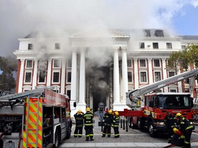 Firefighters work after a fire broke out in the Parliament in Cape Town, South Africa, Jan. 2, 2022.