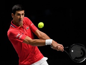 In this file photo taken Dec. 2, 2021 Serbia's Novak Djokovic hits a returns against Kazakhstan's Alexander Bublik during the men's singles quarterfinal Davis Cup match at the Madrid Arena in Madrid, Spain.