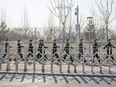 Peoples Liberation Army soldiers march along the perimeter of the closed loop system at the Big Air Shougang ahead of the Beijing Winter Olympics on Jan. 29, 2022 in Beijing.