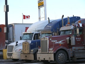 Transport trucks parked at the Roadking Travel Centre in Calgary. Vaccine mandates at the U.S. border could exacerbate supply chain problems. Photo taken on Tuesday, January 11, 2022.