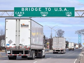 Transport trucks approach the Canada/USA border crossing in Windsor in this file photo from March 2020.