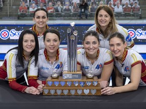 Front, from left, Kerri Einarson, third Val Sweeting, second Shannon Birchard, lead Briane Meilleur, and back, from left, fifth Krysten Karwacki and coach Heather Nedohin, celebrate their Scotties Tournament of Hearts championship at the Markin MacPhail Centre in Calgary on Feb. 28, 2021.