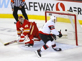The Ottawa Senators’ Nick Paul scores on Calgary Flames goalie Jacob Markstrom at Scotiabank Saddledome in Calgary on Thursday, Jan. 13, 2022.