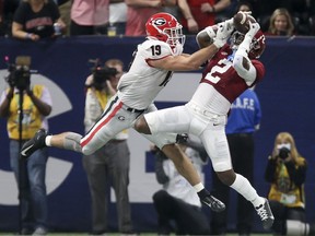 Alabama Crimson Tide defensive back DeMarcco Hellams intercepts a pass intended for Georgia Bulldogs tight end Brock Bowers during the SEC championship game at Mercedes-Benz Stadium in Atlanta on Dec. 4, 2021.