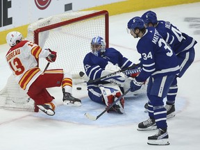 Johnny Gaudreau buries the puck behind  Toronto Maple Leafs goaltender David Rittich in overtime in Toronto on April 13, 2021.