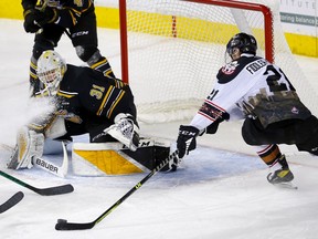 The Calgary Hitmen’s Riley Fiddler-Schultz is stopped by Brandon Wheat Kings goaltender Carson Bjarnason at Scotiabank Saddledome in Calgary on Sunday, Jan. 16, 2022.