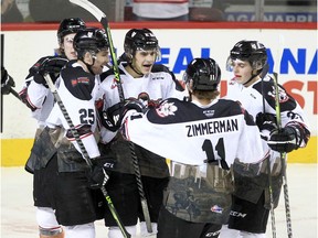 The Calgary Hitmen, pictured celebrating a goal during a game earlier this season, largely dictated action against the Moose Jaw Warriors on Sunday but fell 4-1 to their rivals.
