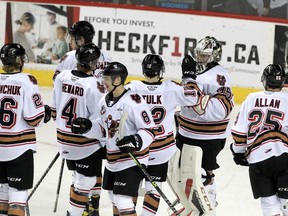 The Calgary Hitmen celebrate a 3-1 win over the Medicine Hat Tigers 3-1 at the Scotiabank Saddledome in Calgary on Tuesday, Dec. 28, 2021.