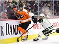 The Philadelphia Flyers’ Keith Yandle, left, and the Dallas Stars’ Luke Glendening battle along the boards at the Wells Fargo Center in Philadelphia on Monday, Jan. 24, 2022. Yandle tied the NHL record for consecutive games played with 964.