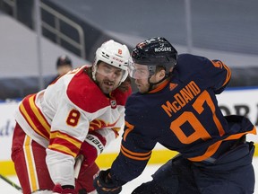 Edmonton Oilers Connor McDavid (97) scores on the Calgary Flames as he gets the puck past Christopher Tanev (8) during first period NHL action on Saturday, May 1, 2021 in Edmonton. Greg Southam-Postmedia
